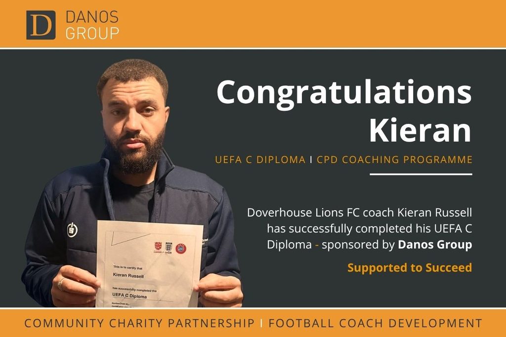 A man proudly holds a UEFA C Diploma certificate in front of a “Congratulations Kieran” sign, symbolising dedication, achievement, and commitment to professional development—values integral to effective governance and compliance solutions.